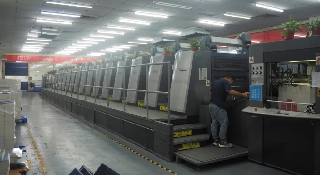High-tech printing machine with a worker operating in a modern packaging production facility.
