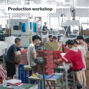 Workers performing post-process die cutting in Baoyuan Packaging's facility.