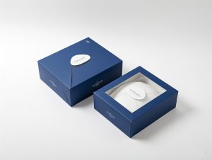 High-end custom hat packaging with a refined dark blue finish, featuring a unique closure design and a transparent window for an elegant unboxing experience.