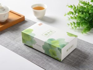 Elegant white tea packaging box with green leaf design, ideal for premium tea brands.